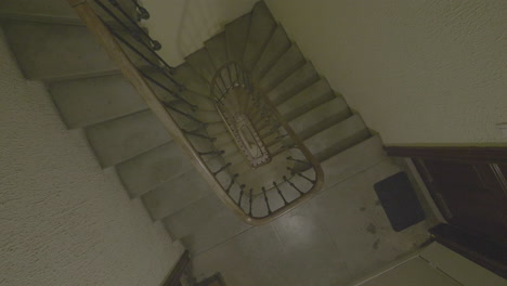 Top-down-shot-going-down-in-a-staircase.-Pan-moving-180